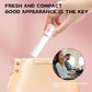 Hand slipping the closed Breeze Lipstick Vibrator in its sleek white casing into a handbag for discreet travel.