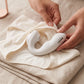 Hands tucking the Pure White Fizzglow Pearl Wearable G-Spot Vibrator into everyday cotton underwear to demonstrate a discreet hands-free wearable fit