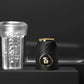 Disassembled Vault Male Penis Pump components showing transparent acrylic cylinder, black control handle with gold crown ring, and textured liquid silicone sleeve
